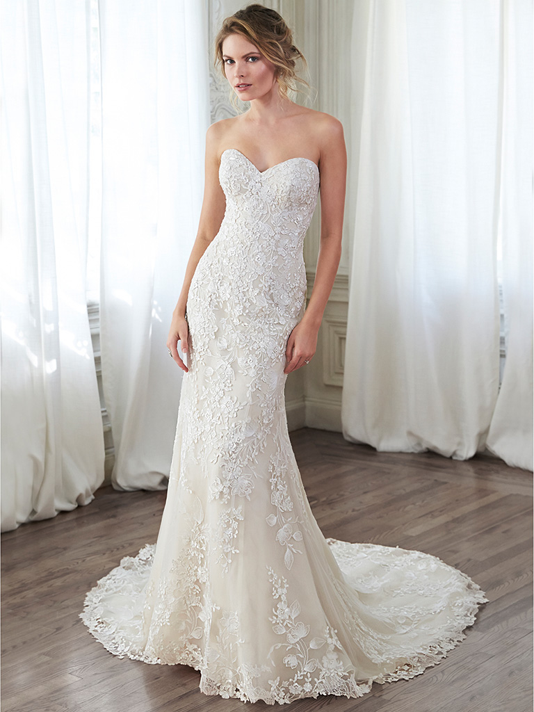 Arlyn: This lace slim A-line gown channels timeless elegance with its classic sweetheart neckline, cascading floral lace appliqués, lace-trimmed hemline and optional lace cap-sleeves.