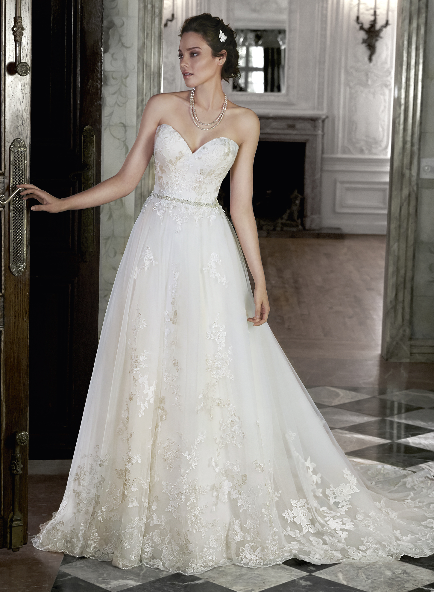 Lauralee: Perfect for the hopeless romantic, this ballgown features layers of tulle adorned with metallic floral lace appliqués. Complete with Swarovski crystal belt accenting the waist.