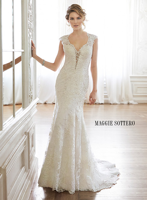 Melitta Marie: The perfect blend of sophisticated romance is found in this lace slim A-line wedding dress complete with plunging illusion neckline, lace sleeves, and daring keyhole back.