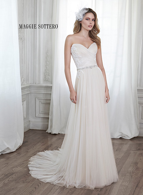 Patience: This stunning tulle sheath gown is accented with dainty lace appliqués on the bodice and a delicate Swarovski crystal waist. Finished with sweetheart neckline and corset back closure.